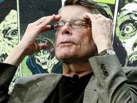 Stephen King sitting in front of Marvel Comics' X-Men issue Heroes For Hope