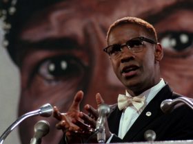 Malcolm X, as played by Denzel Washington, giving a speech