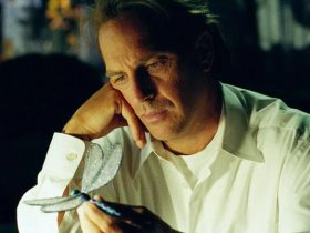 Kevin Costner as Dr. Joe Darrow, contemplating a dragonfly, in Dragonfly