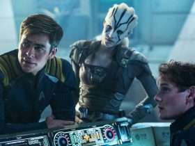 Chris Pine, Sofia Boutella, and Anton Yelchin huddle around a console in Star Trek Beyond