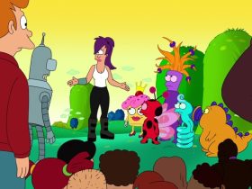 Leela stands next to several cute, kid-friendly creatures while Fry, Bender, and several orphans look on in Futurama