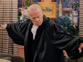 Frasier poses dramatically in a living room wearing black robes as part of a murder mystery party