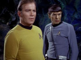 Captain Kirk and Spock in a cave, looking at something concerning in Star Trek