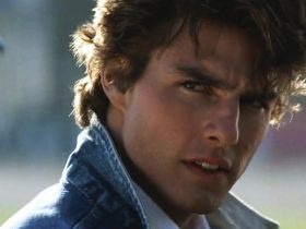 Cole Trickle wearing a jean jacket and giving a piercing look in Days of Thunder