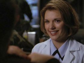 Dr. Janet Fraiser wearing a lab coat and smiling at someone in Stargate SG-1