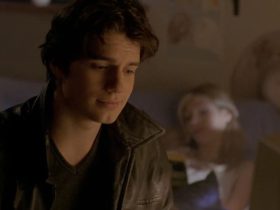 Henry Cavill's Mike smiling and looking downward, and a woman out of focus in the background, in Hellraiser: Hellworld