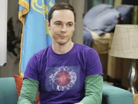 Sheldon Cooper sitting on a couch and smirking on The Big Bang Theory