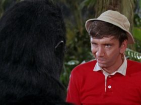 Gilligan making a face at a guy in a ratty gorilla costume