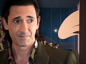 Adrien Brody next to a parody of his nose coming out of a movie screen in Family Guy