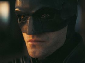 Robert Pattinson as Batman stares into the distance in The Batman