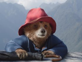 Paddington holds an umbrella in the mountains in Paddington in Peru