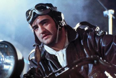 John Belushi as Captain Wild Bill Kelso astride a motorcycle in 1941